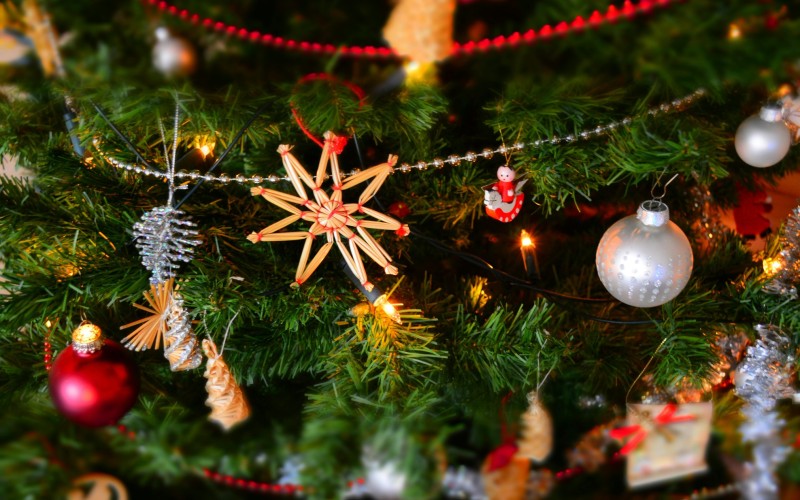 Close up of Christmas tree with lights, decorations and garlands