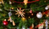 Close up of Christmas tree with lights, decorations and garlands