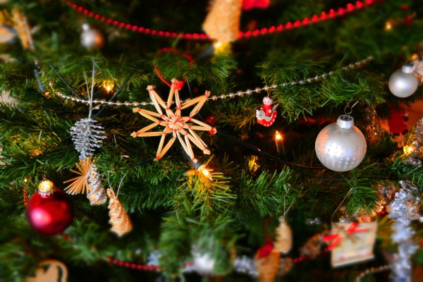 Close up of Christmas tree with lights, decorations and garlands